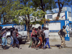 Inmates are escorted by police back to the Croix-des-Bouquets Civil Prison after an attempted breakout. It was reported that a couple of hundred escaped with only a handful captured.(AP Photo/Dieu Nalio Chery)
